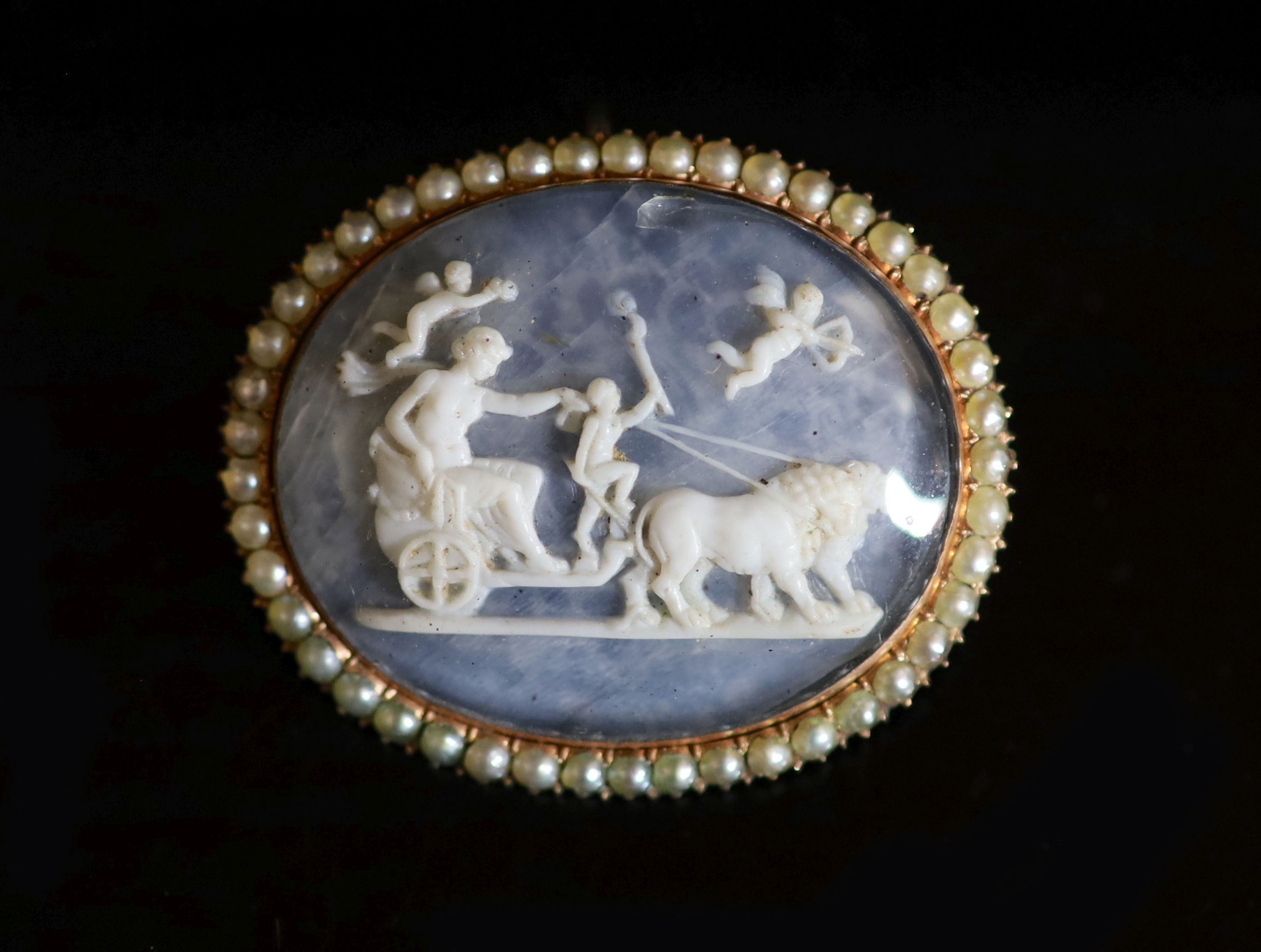 An early 20th century gold and seed pearl set oval glazed cameo brooch